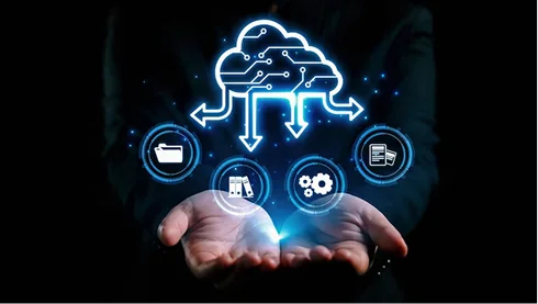 A close-up view of a software developer working on a laptop, with code visible on the screen. The code appears to be written in React, with syntax highlighting showing key components like imports and state management. The background is dimly lit, focusing attention on the developer's hands and the screen, symbolizing the dynamic and technical nature of software development in a modern workspace.